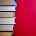 Stack of hardcover encyclopedias against red background